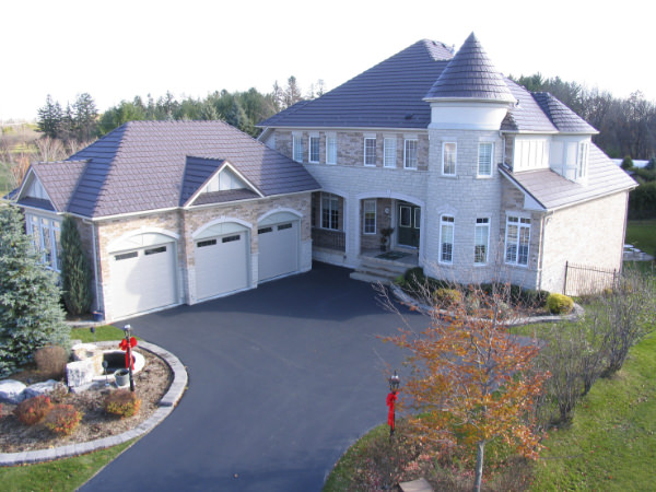Metal Shingle Style roof on large brick house with turrets